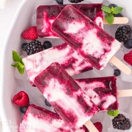 a pile of berries and cream popsicles in a bowl