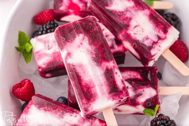 a pile of berries and cream popsicles in a bowl