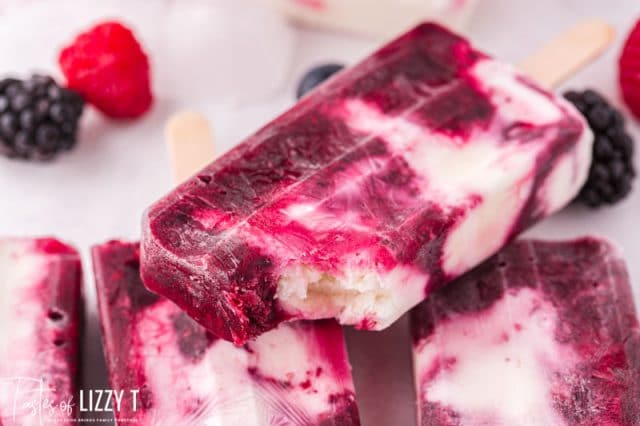 berry popsicle with one bite out