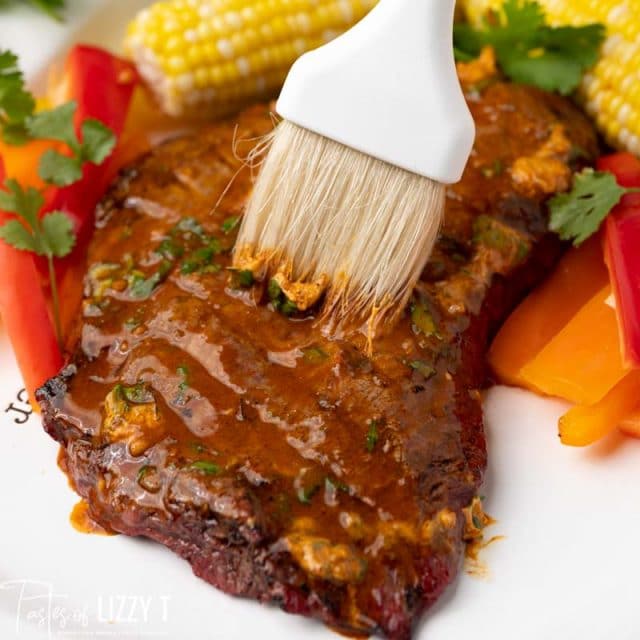 brushing chili lime butter on steak