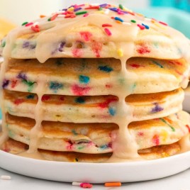 stack of birthday pancakes with glaze