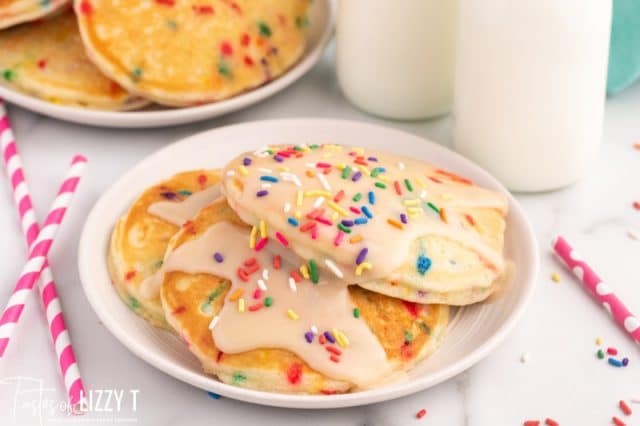 3 pancakes with glaze and sprinkles on a plate