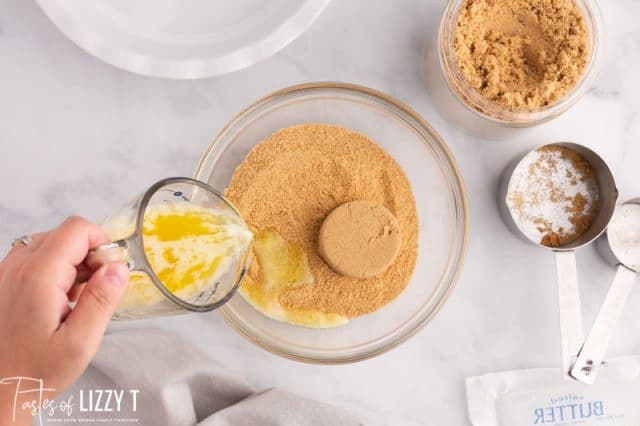 pouring butter in graham cracker crumbs