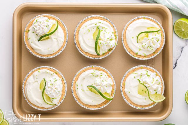 6 mini key lime pies on a baking sheet