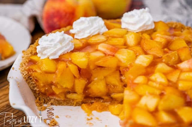 half of a jello peach pie with whipped cream