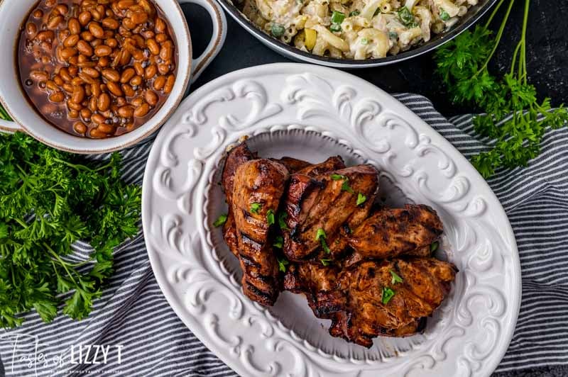 bbq pork, beans and salad on a table