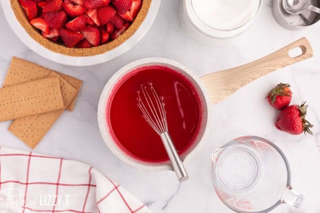 thickened strawberry jello for pie in a pan
