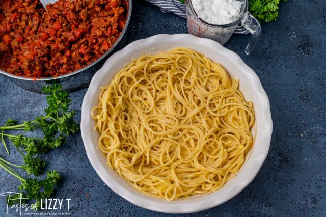 spaghetti in the bottom of a pie plate