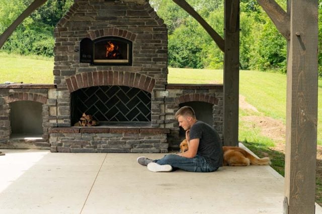 boy sitting in front of fireplace