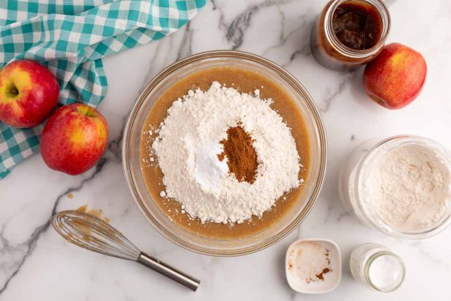 dry ingredients on wet ingredients in a mixing bowl