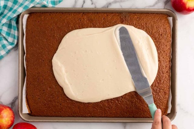 spreading frosting on a warm sheet cake