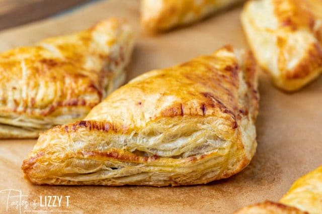 golden brown apple pastry on a baking sheet