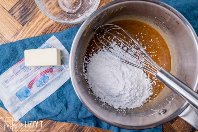mixing powdered sugar into butterscotch sauce