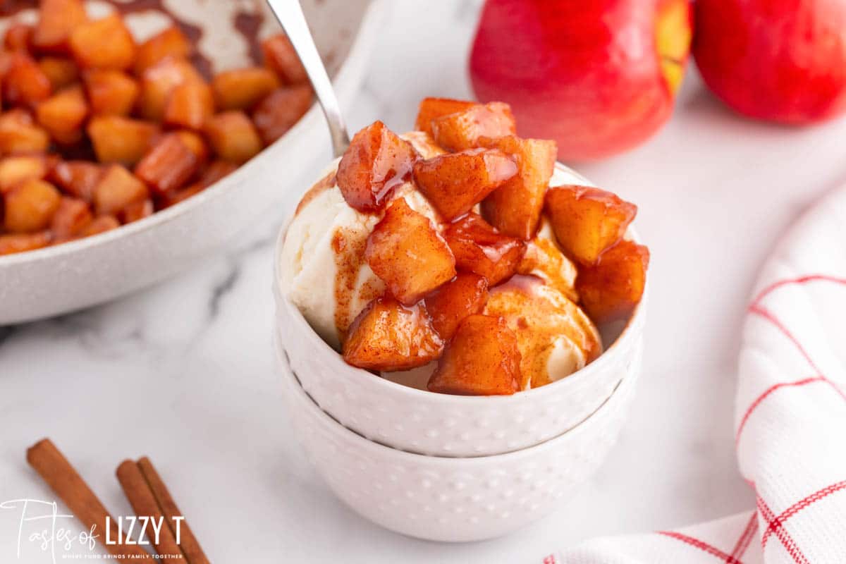 fried apples over ice cream in a bowl