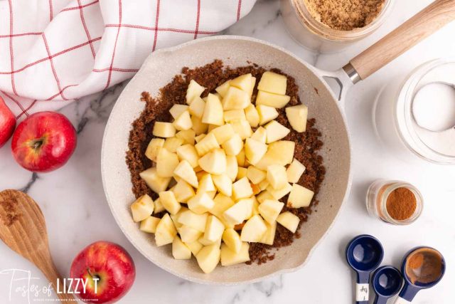 apples over brown sugar and butter in a skillet