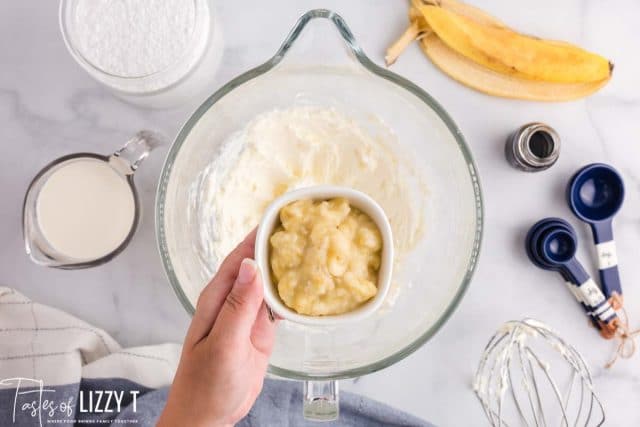 mashed bananas in a bowl with cream cheese