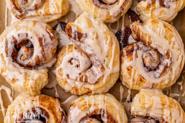 cinnamon pastries with glaze on a baking sheet