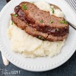 meatloaf over mashed potatoes on a plate