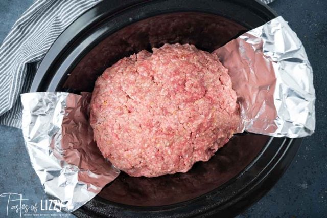 uncooked meatloaf in a slow cooker