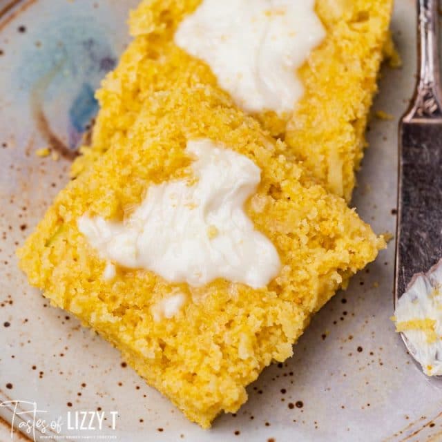 a slice of buttered cornbread on a plate