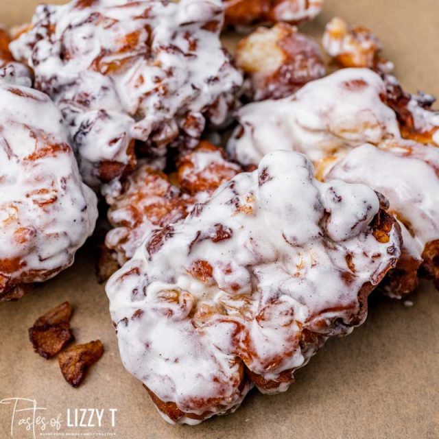 closeup of apple fritter donuts on parchment paper