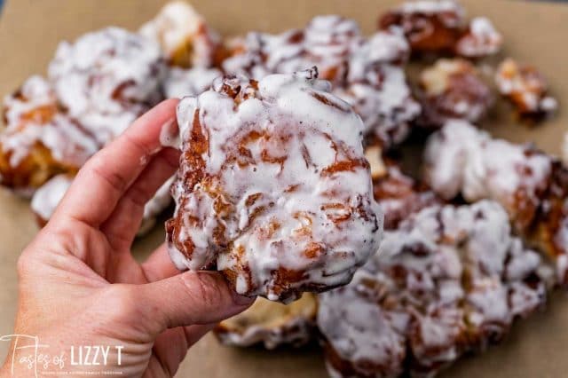 hand holding an apple fritter