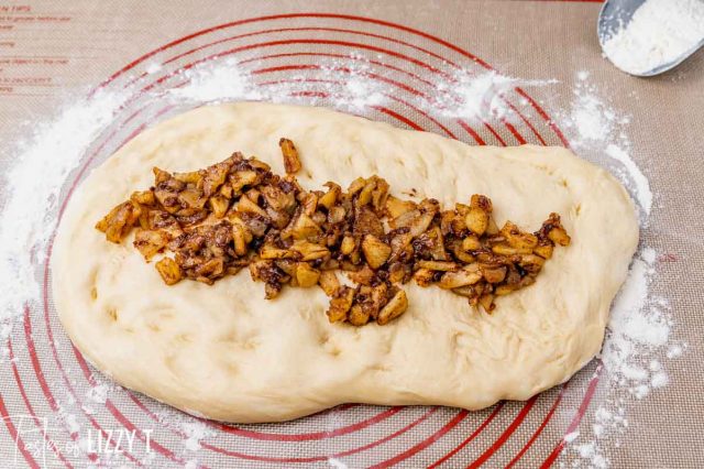 donut dough with apple pie filling down the middle