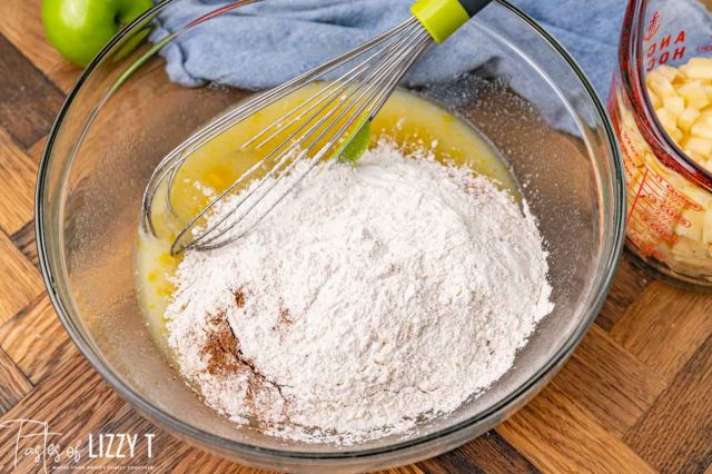 dry ingredients on wet ingredients in a mixing bowl