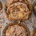 an apple muffin cut in half on a baking sheet