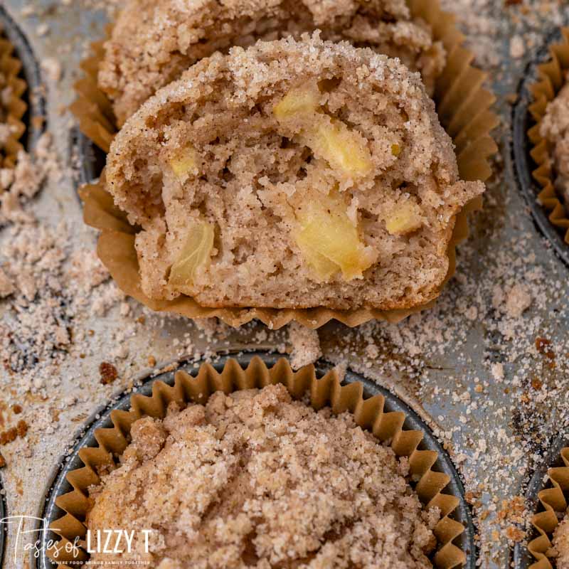 an apple muffin cut in half on a baking sheet