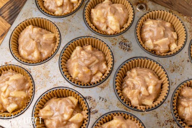 unbaked apple muffins in a baking pan
