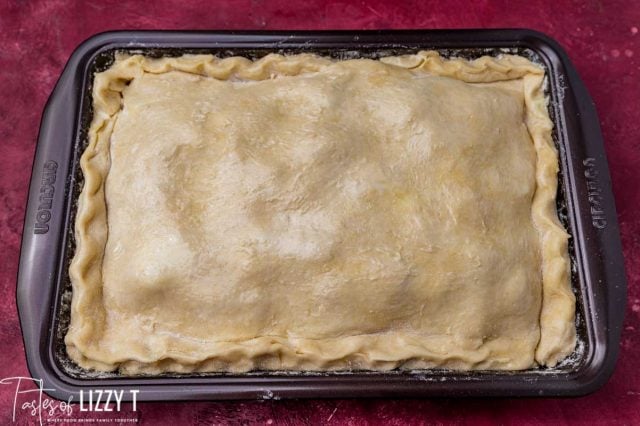 unbaked apple pie in a baking pan