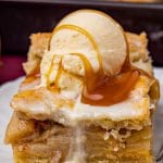 a piece of apple pie bar with ice cream and caramel