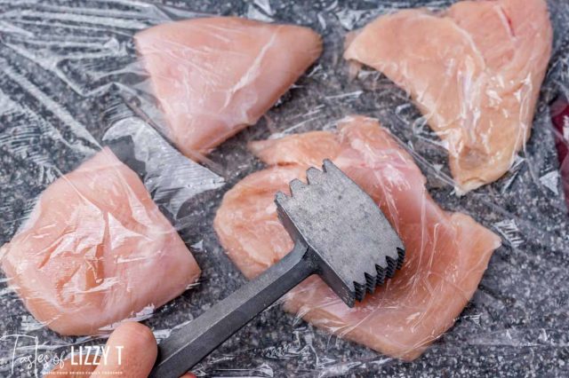 meat mallet pounding chicken breasts flat