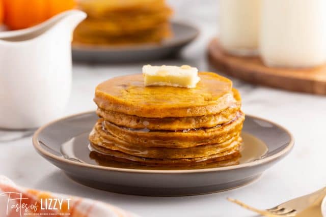 a stack of pancakes with butter and syrup