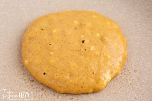 closeup of a pancake cooking on a skillet