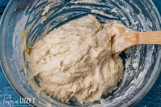 sticky bread dough in a glass bowl