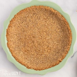 overhead view of a pie crust in a green pie plate