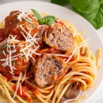 a plate full of spaghetti and meatballs