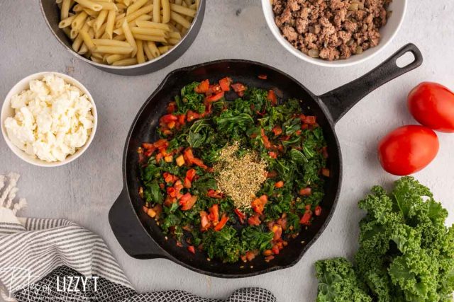 kale and tomato in a skillet