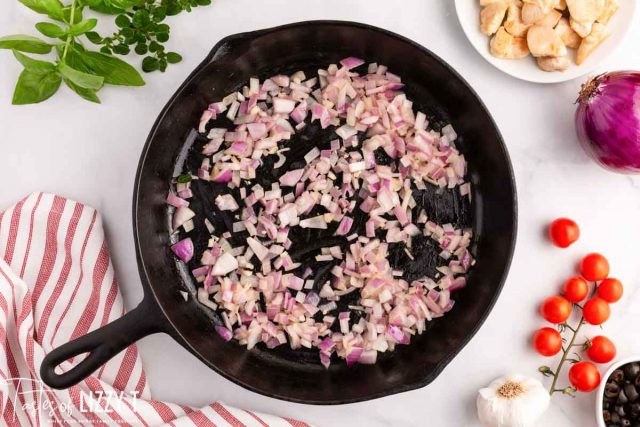 red onions in a cast iron skillet