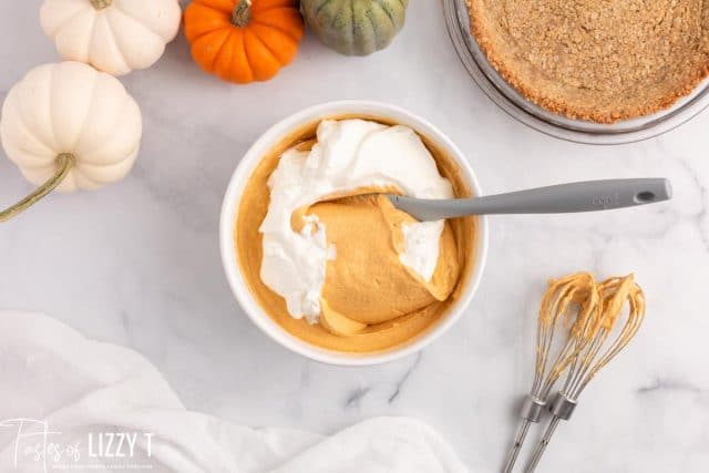 folding whipped cream into pumpkin mixture