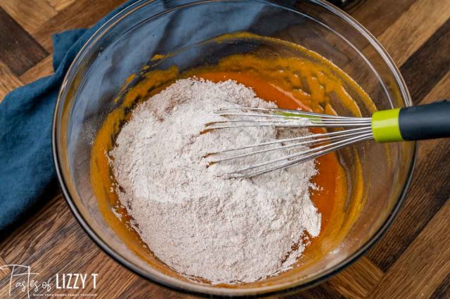 flour over wet ingredients in a mixing bowl