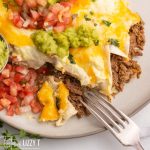 enchiladas with guacamole and fresh salsa on a plate