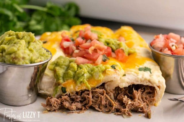 a plate of roast beef enchiladas with guacamole