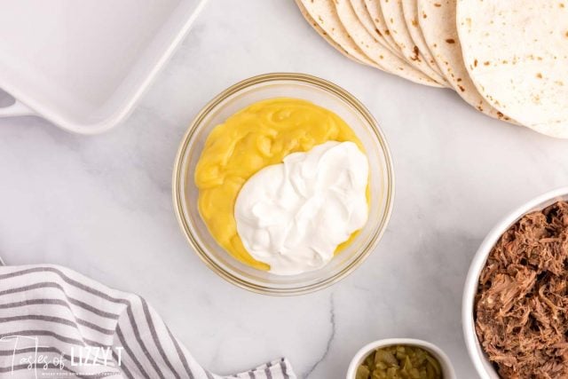 cream of chicken soup and sour cream in a glass bowl