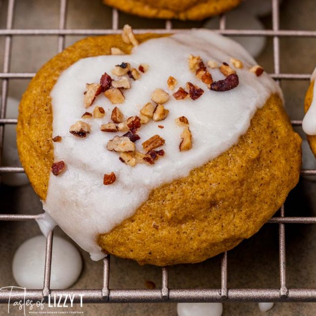 an iced cookie with pecans on a wire rack