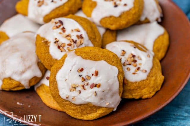 a plate of iced pumpkin cookies