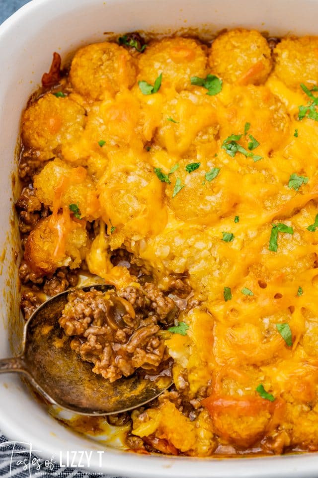 tater tot casserole with a serving spoon