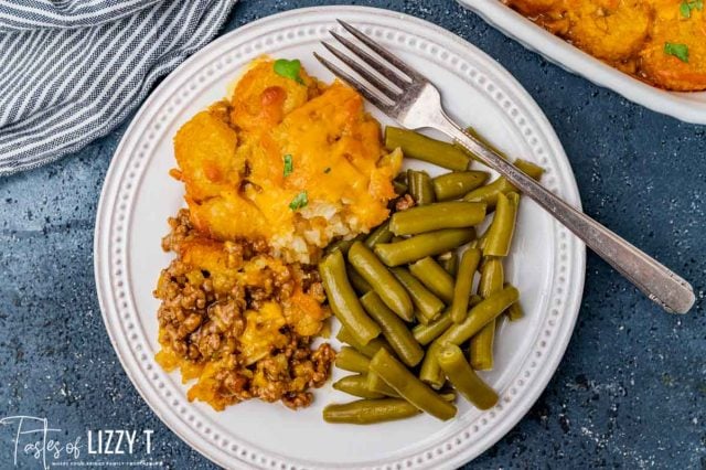 overhead view of a plate of tater tot casserole and green beans
